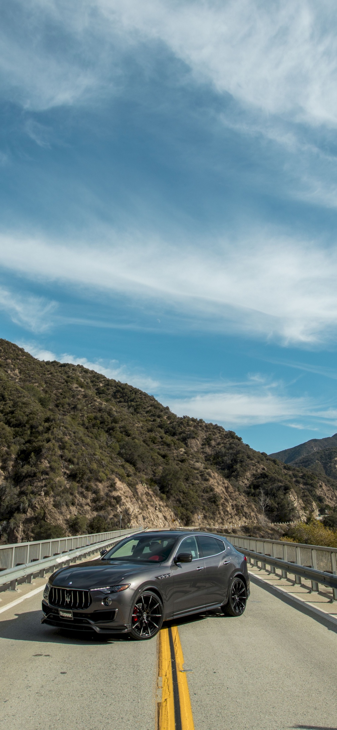 Black Car on Road During Daytime. Wallpaper in 1125x2436 Resolution