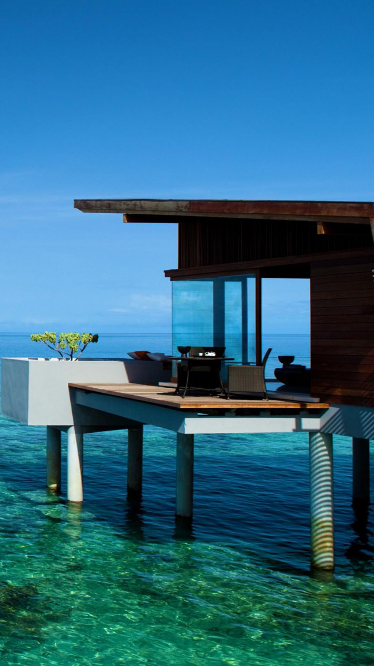 Brown Wooden Dock on Blue Sea Under Blue Sky During Daytime. Wallpaper in 750x1334 Resolution