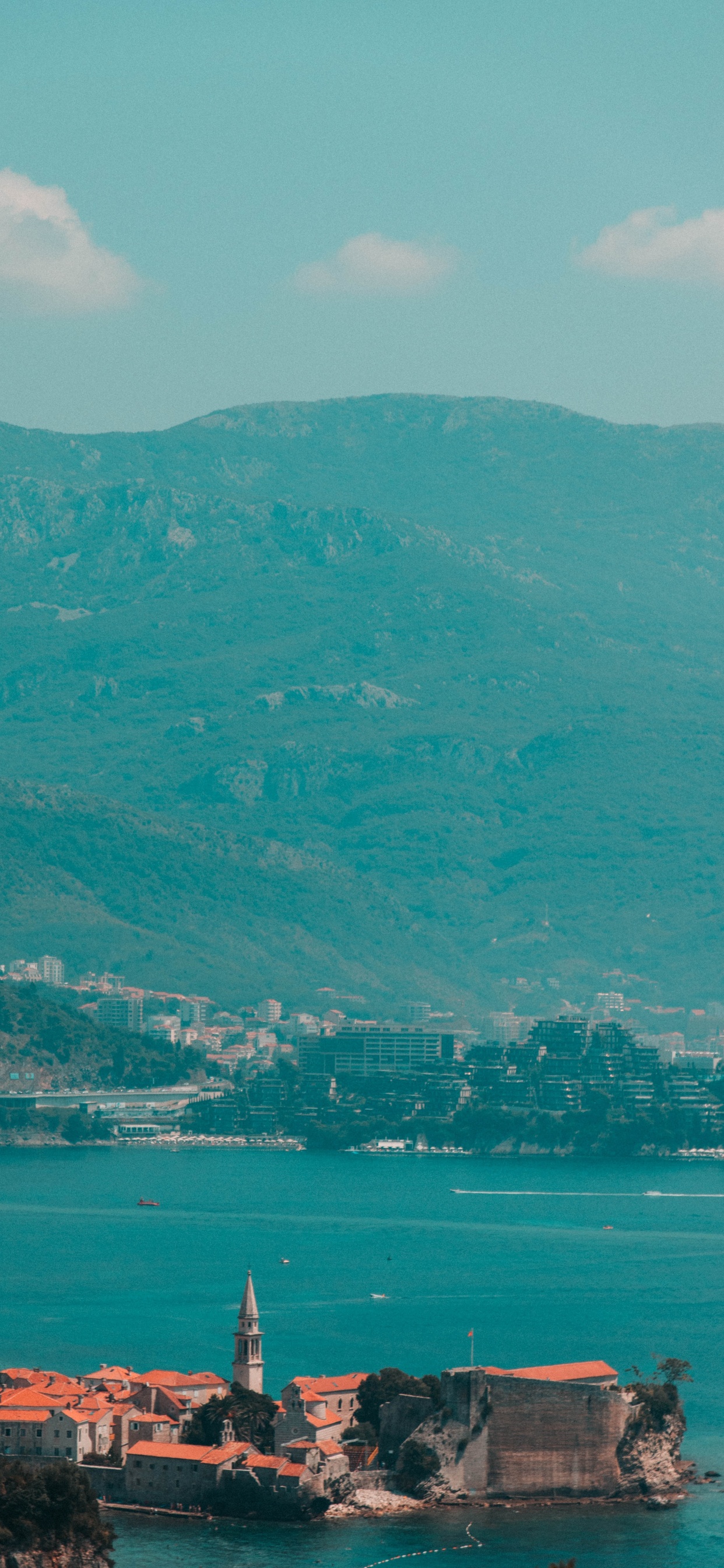 Green Mountains Near Body of Water During Daytime. Wallpaper in 1242x2688 Resolution