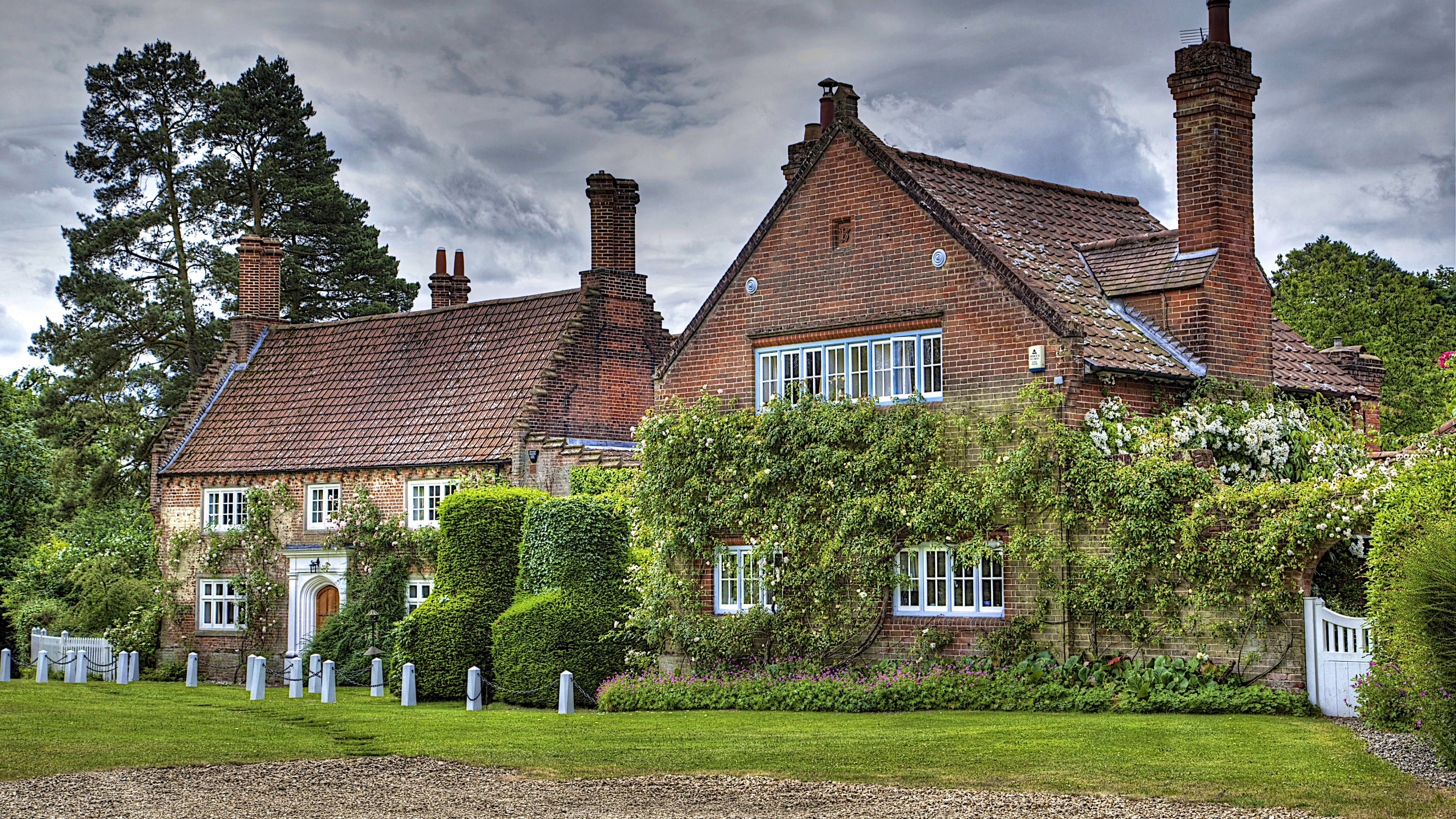 Brown Brick House With Green Grass Lawn and Trees Under Gray Clouds. Wallpaper in 3840x2160 Resolution