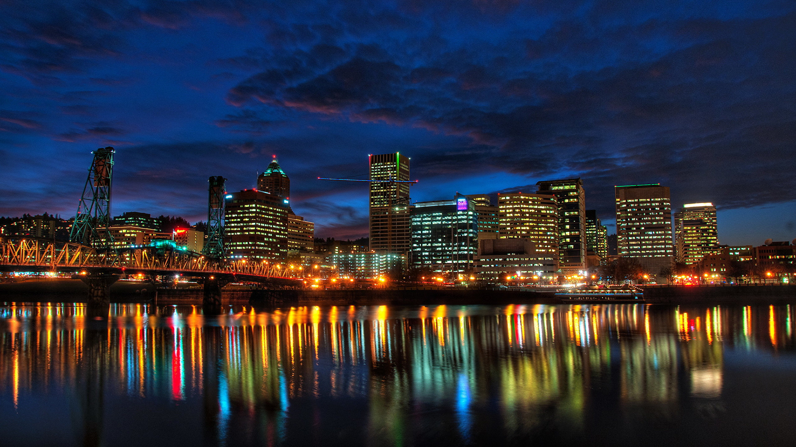 City Skyline Across Body of Water During Night Time. Wallpaper in 2560x1440 Resolution