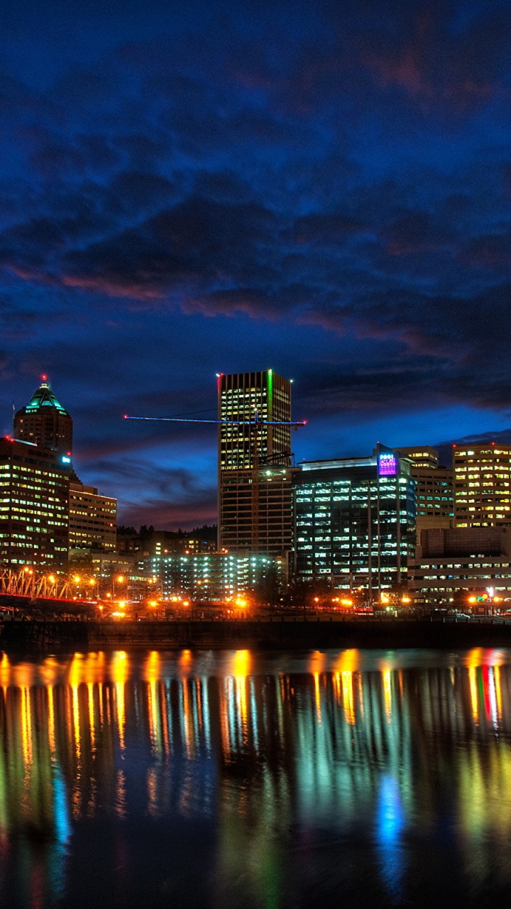 City Skyline Across Body of Water During Night Time. Wallpaper in 720x1280 Resolution