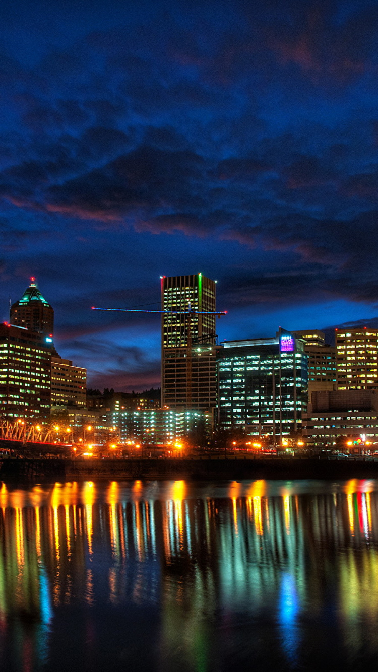 City Skyline Across Body of Water During Night Time. Wallpaper in 750x1334 Resolution