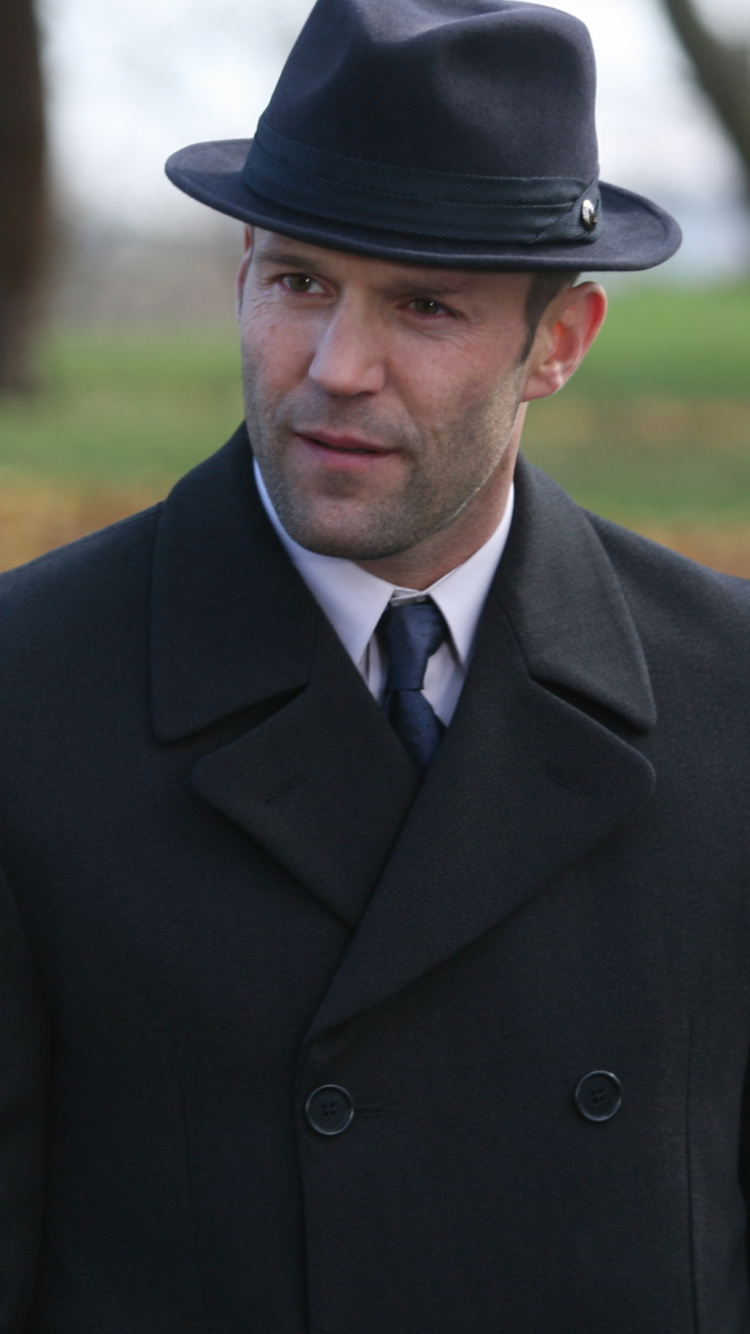Man in Black Suit Jacket and Black Fedora Hat Standing on Green Grass Field During Daytime. Wallpaper in 750x1334 Resolution