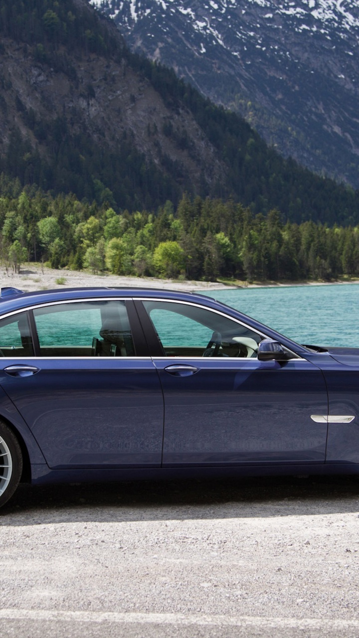 Black Sedan on Gray Asphalt Road During Daytime. Wallpaper in 720x1280 Resolution