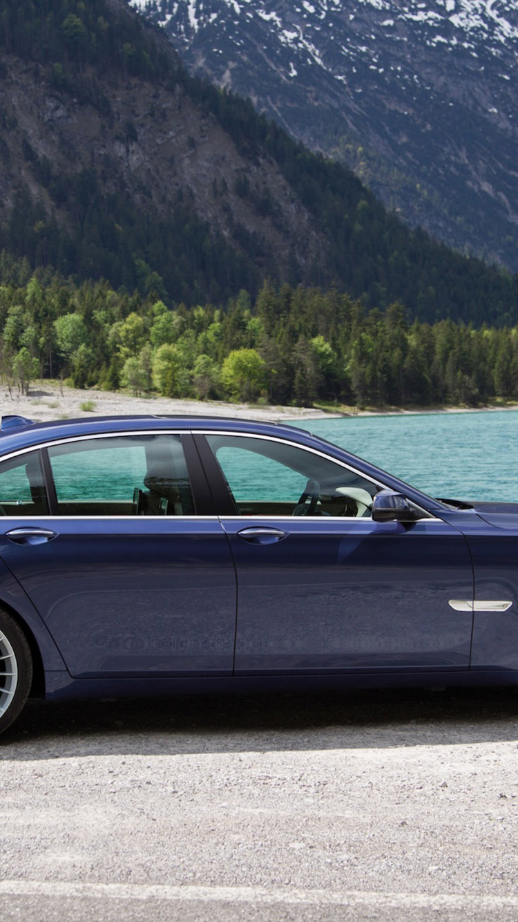 Black Sedan on Gray Asphalt Road During Daytime. Wallpaper in 750x1334 Resolution