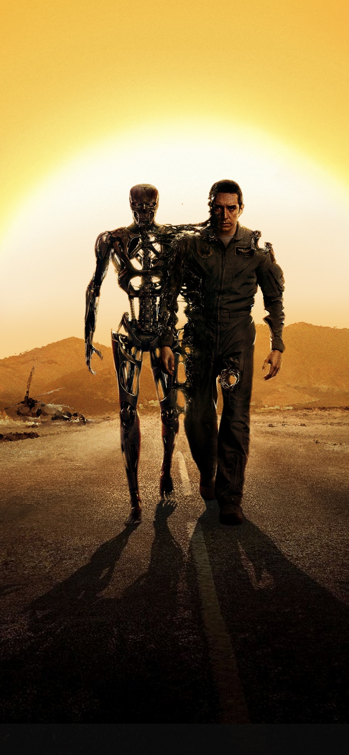 2 Men Standing on Brown Sand During Sunset. Wallpaper in 1125x2436 Resolution