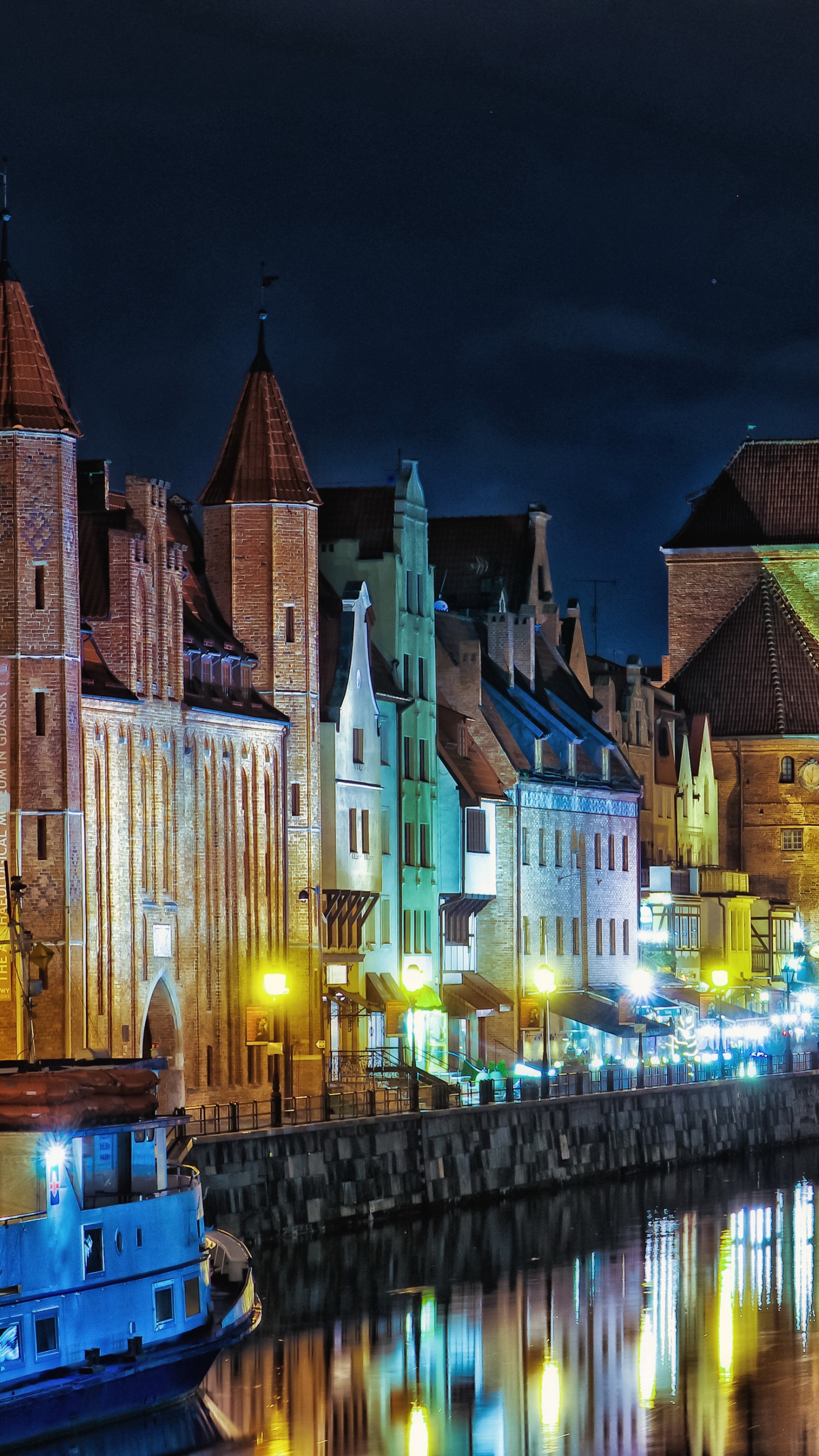Bâtiment en Béton Brun Près D'un Plan D'eau Pendant la Nuit. Wallpaper in 1440x2560 Resolution