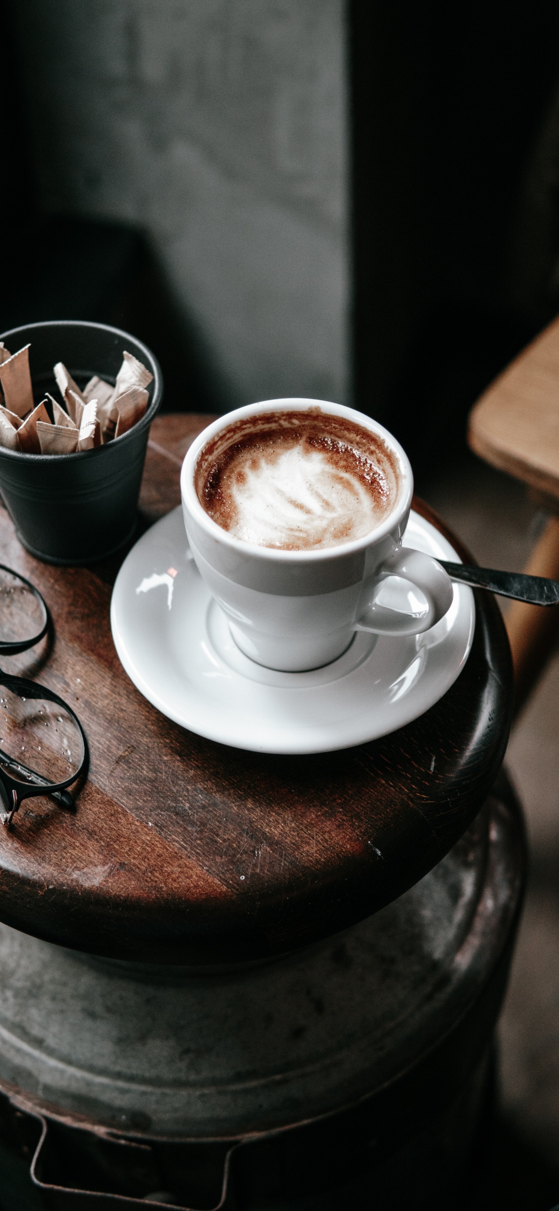 White Ceramic Cup With Saucer on Brown Wooden Round Table. Wallpaper in 1125x2436 Resolution