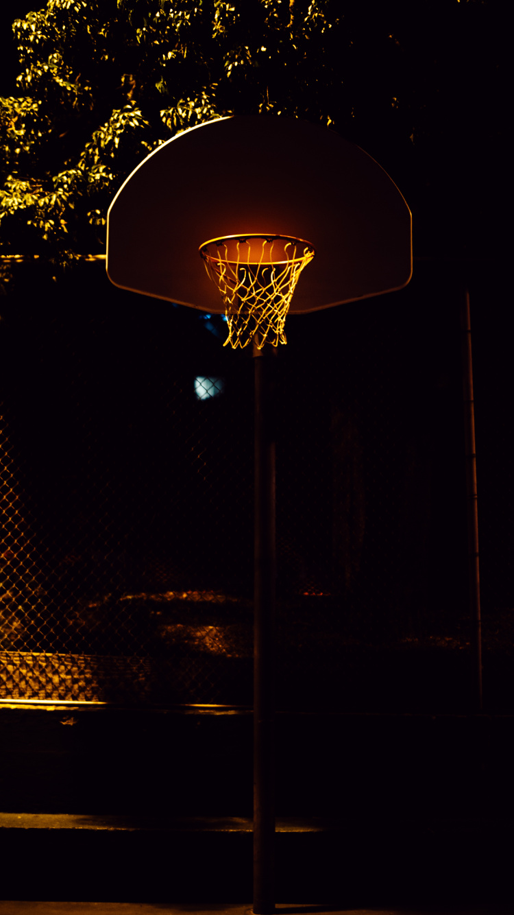 Basketball Hoop With Light Turned on During Night Time. Wallpaper in 750x1334 Resolution
