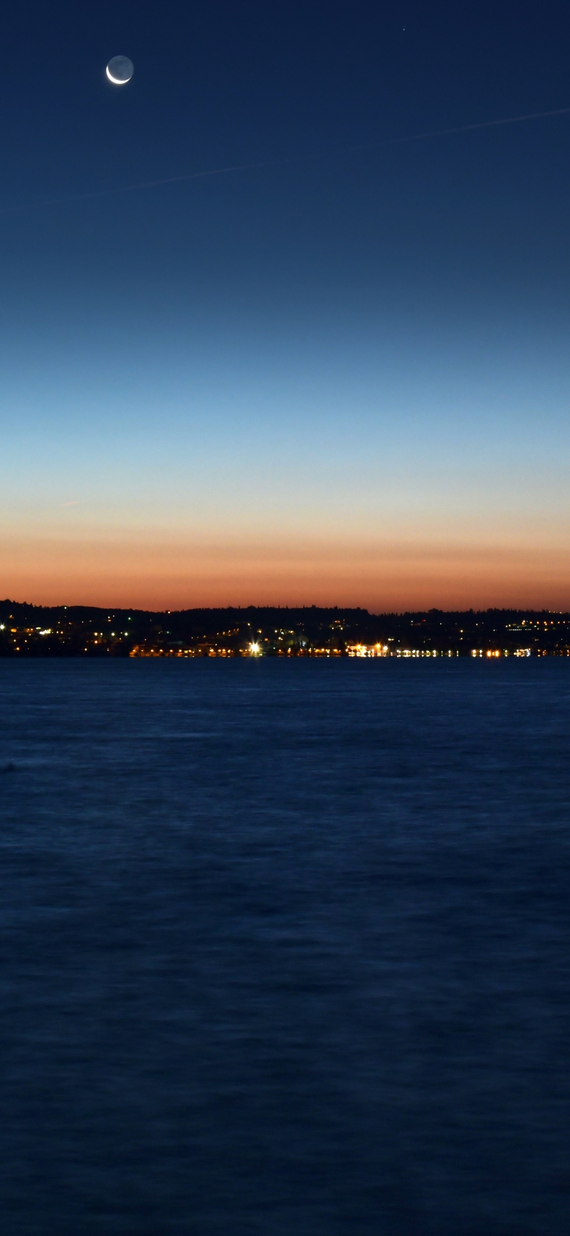 Body of Water Near Mountain During Sunset. Wallpaper in 1125x2436 Resolution