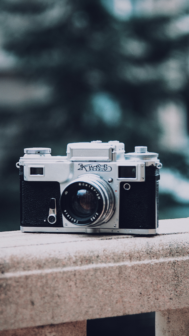 Black and Silver Camera on Gray Concrete Surface. Wallpaper in 750x1334 Resolution