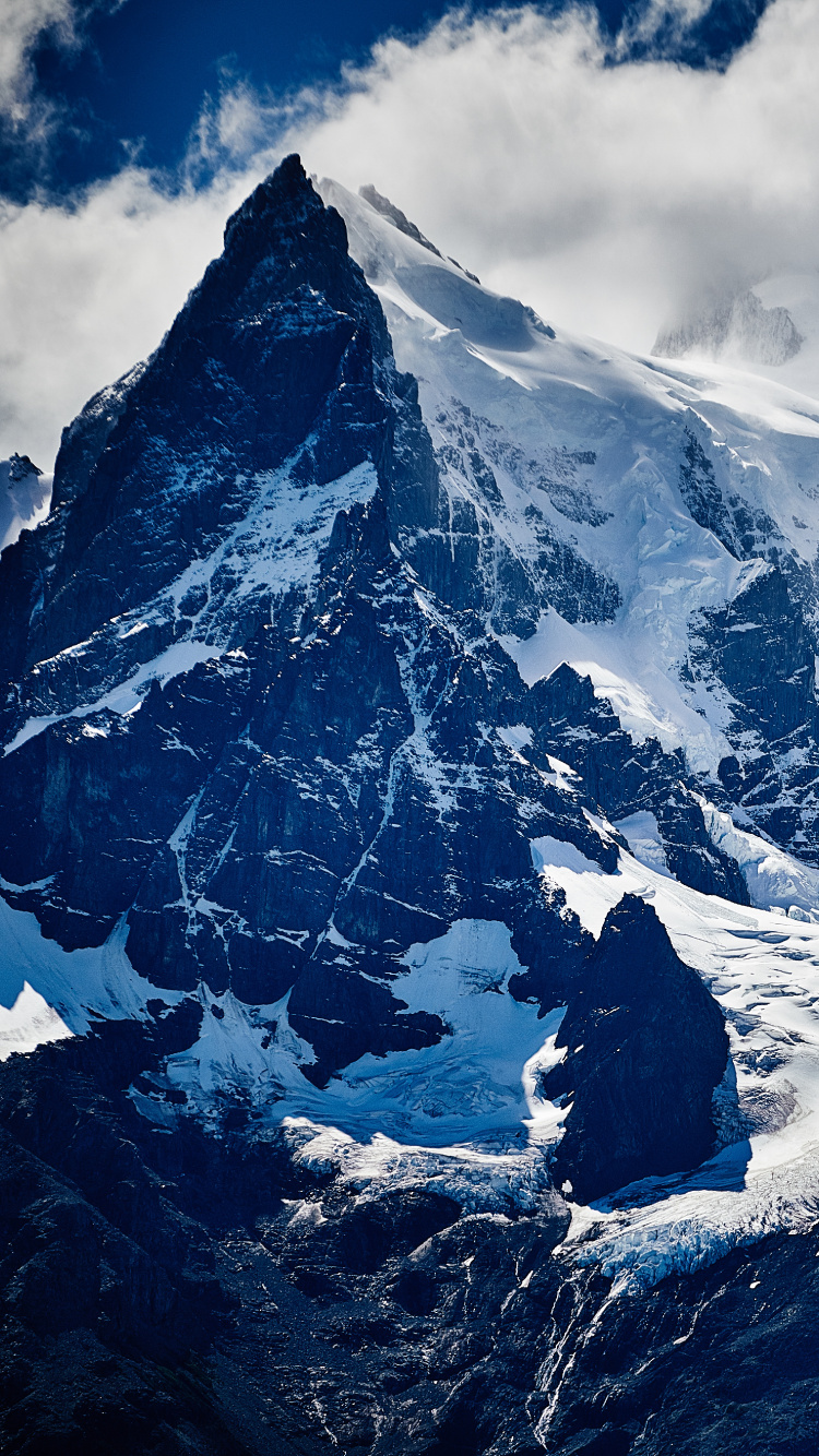 Snow Covered Mountain Under Cloudy Sky During Daytime. Wallpaper in 750x1334 Resolution