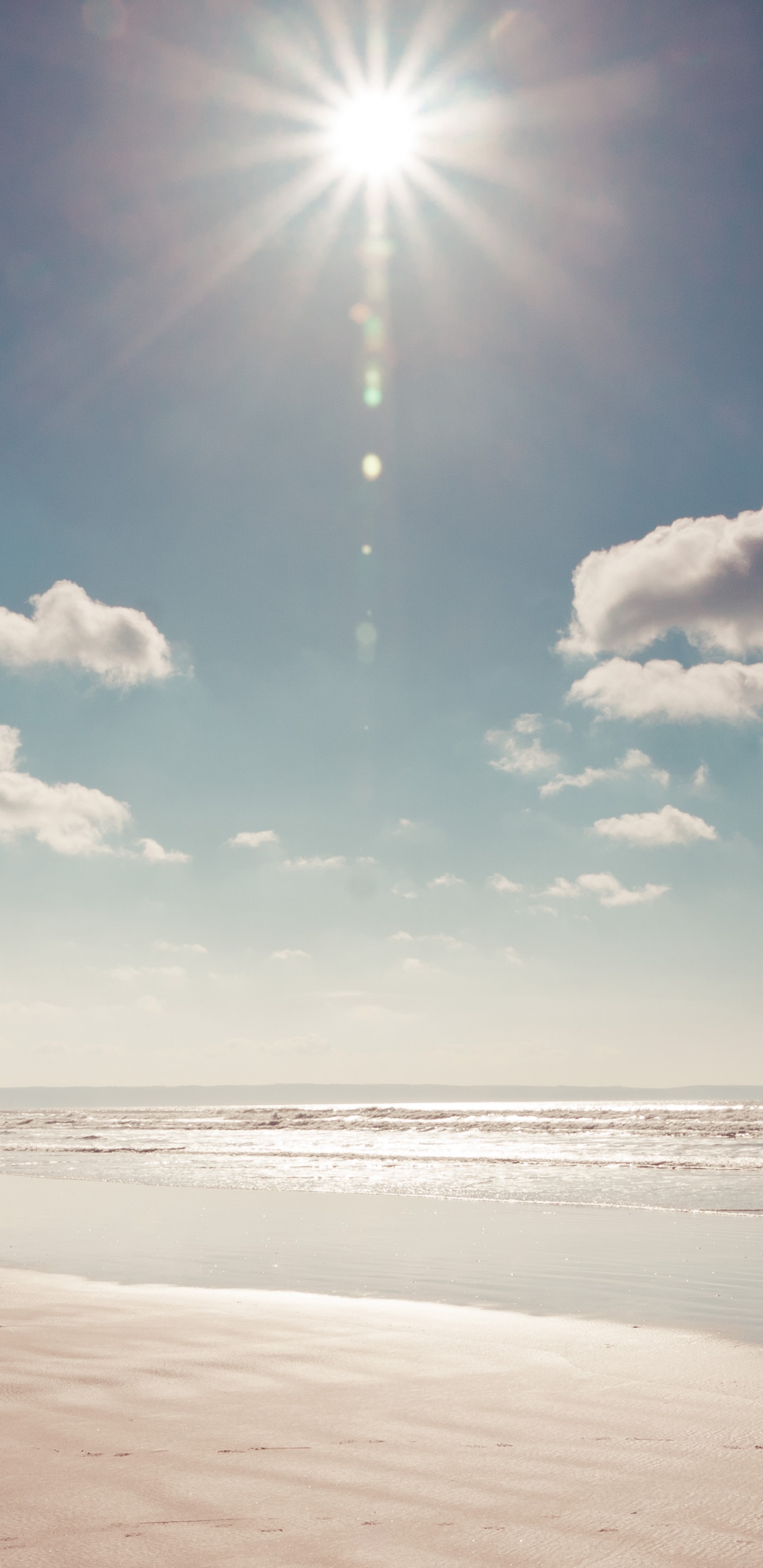 White Clouds and Blue Sky Over The Sea. Wallpaper in 1440x2960 Resolution