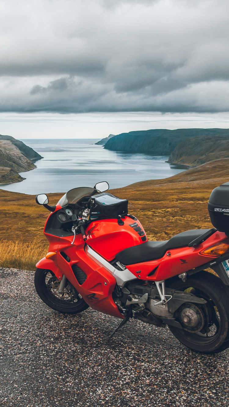 Red and Black Sports Bike Parked on Gray Asphalt Road During Daytime. Wallpaper in 750x1334 Resolution