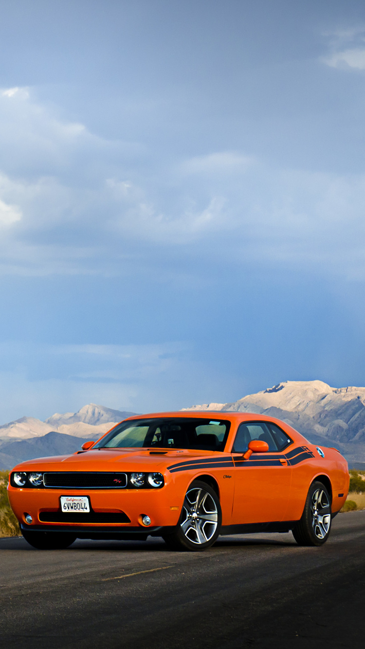 Orange Chevrolet Camaro on Road During Daytime. Wallpaper in 750x1334 Resolution