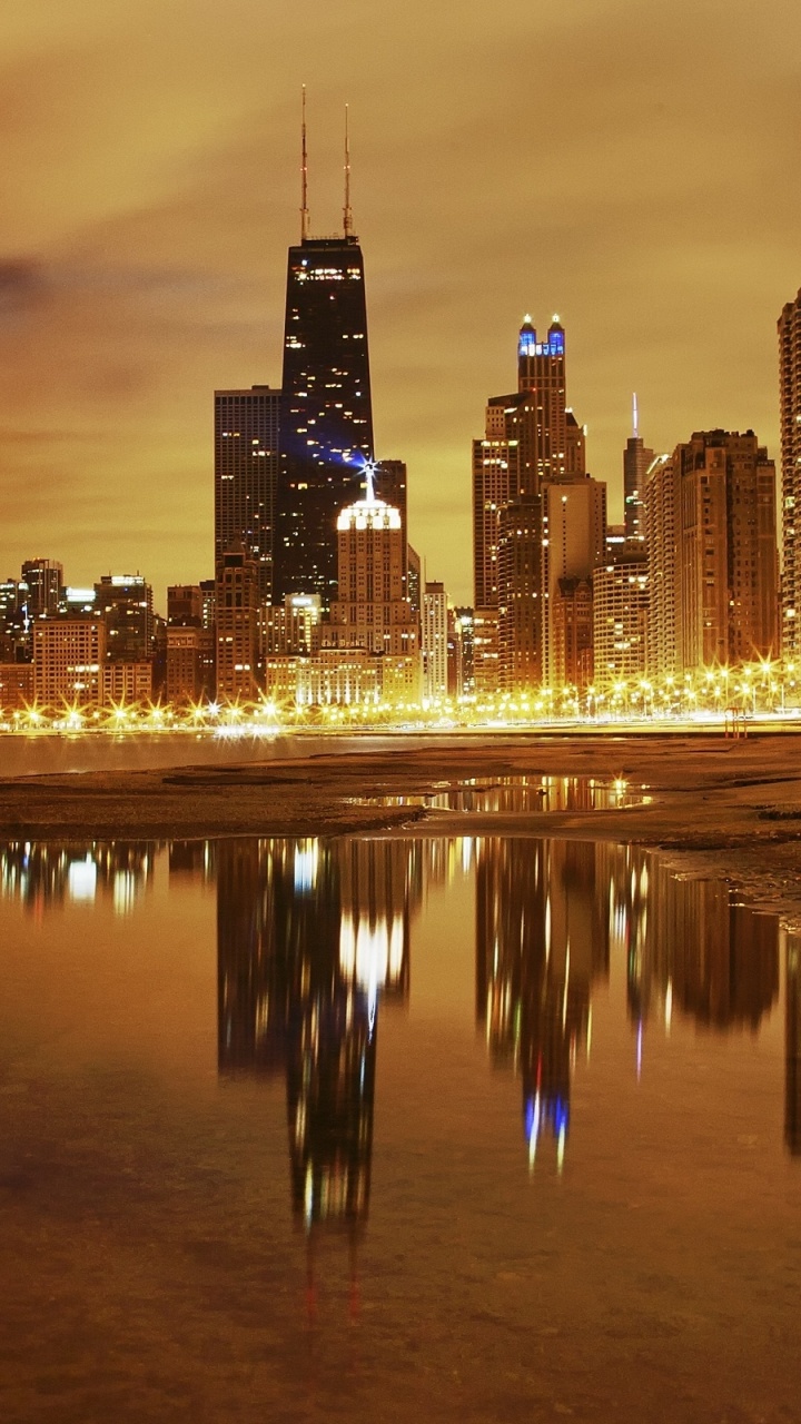 City Skyline Across Body of Water During Night Time. Wallpaper in 720x1280 Resolution