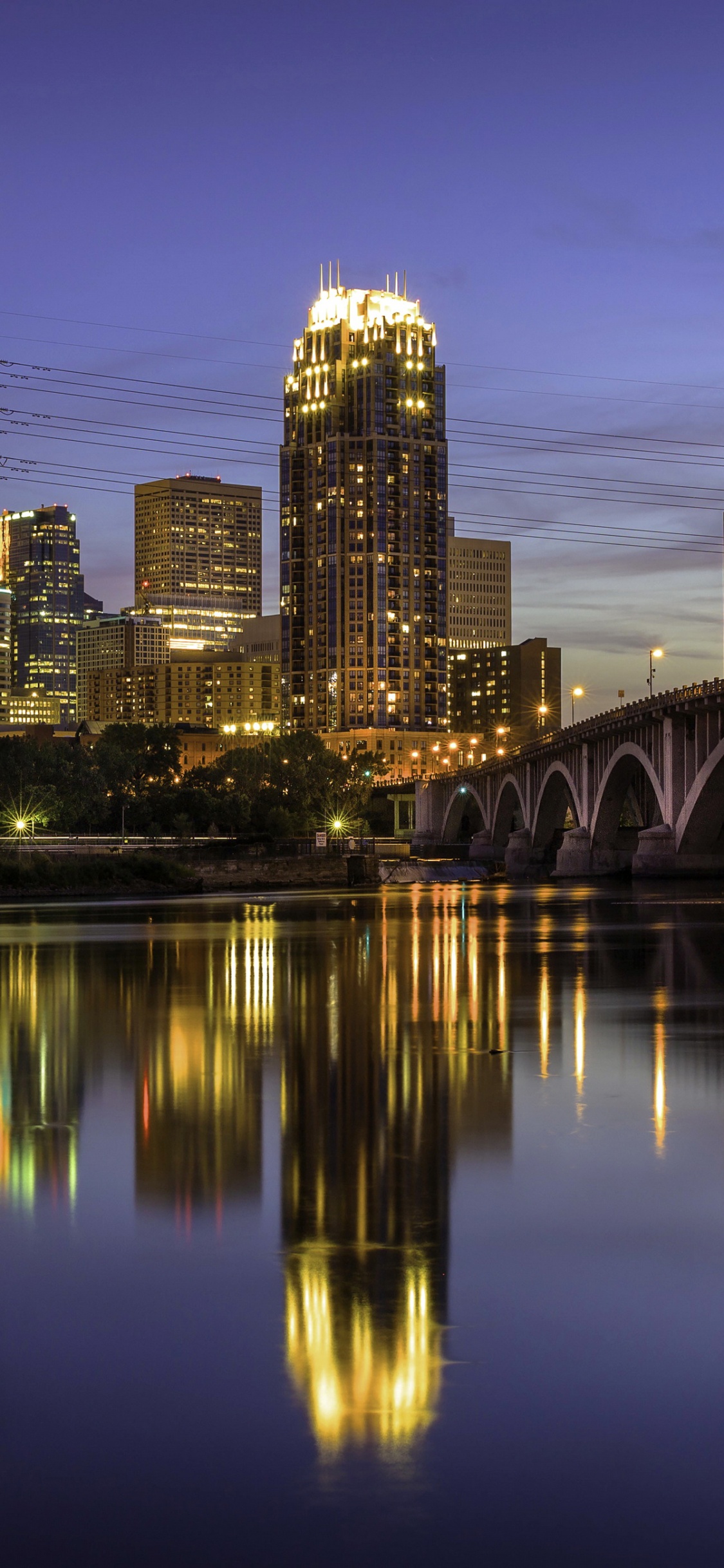 Bridge Over Water During Night Time. Wallpaper in 1125x2436 Resolution