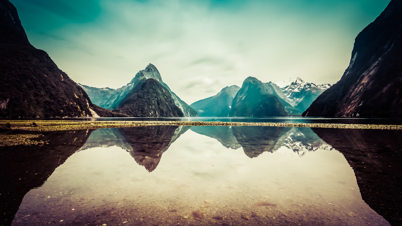 Body of Water Near Mountain Under Blue Sky During Daytime. Wallpaper in 1280x720 Resolution