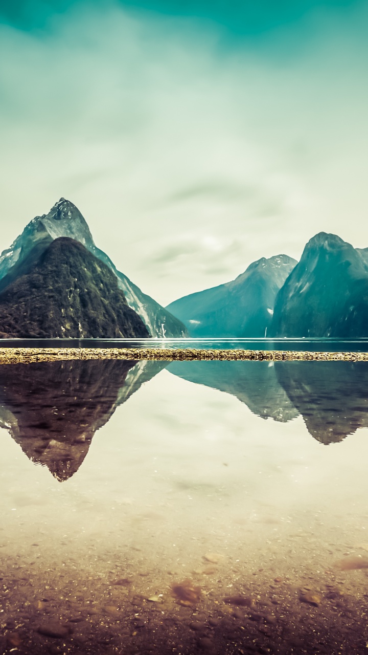 Body of Water Near Mountain Under Blue Sky During Daytime. Wallpaper in 720x1280 Resolution