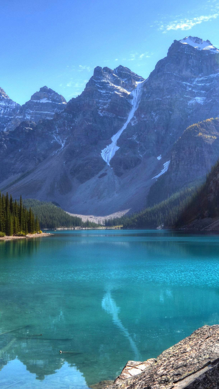 Lake Surrounded by Green Trees and Mountains During Daytime. Wallpaper in 750x1334 Resolution