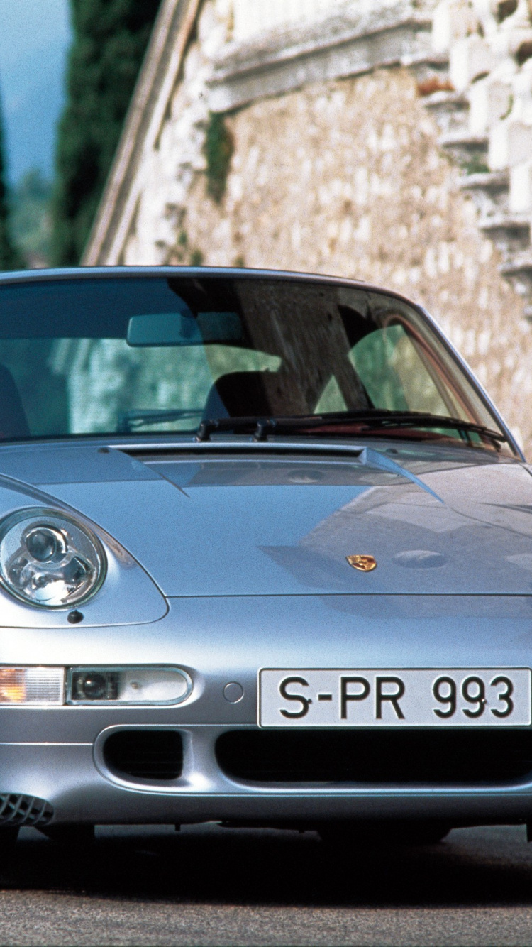 Porsche 911 Bleue Garée Près D'un Mur de Briques Brunes Pendant la Journée. Wallpaper in 750x1334 Resolution