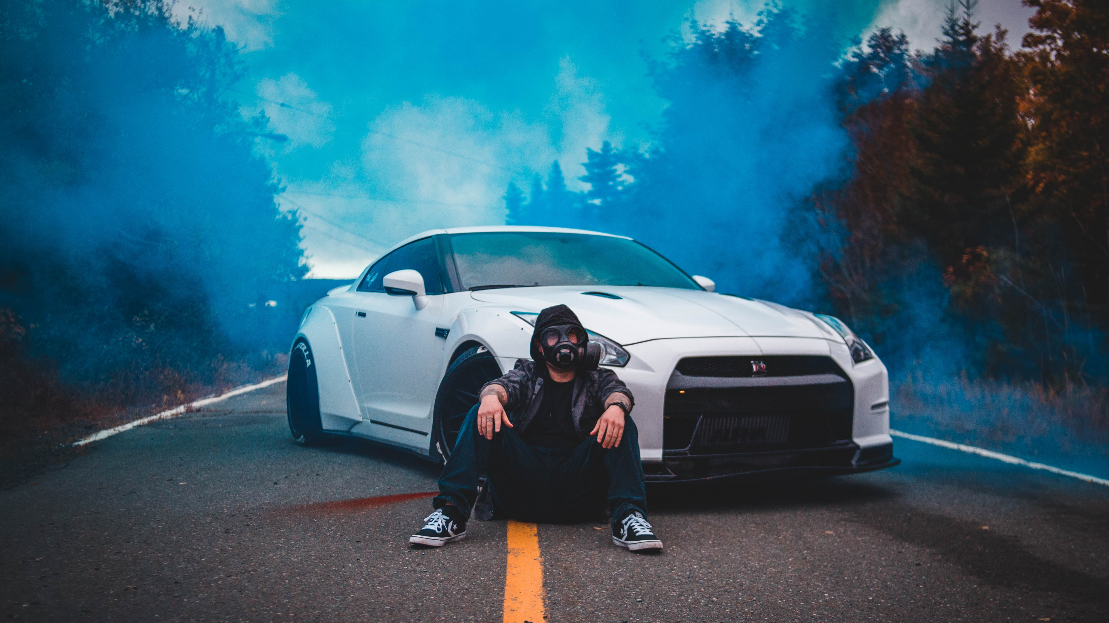 Man in Black Jacket Sitting Beside White Car. Wallpaper in 3840x2160 Resolution