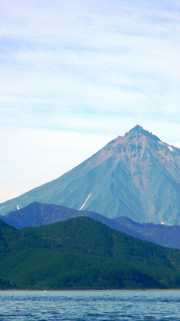 Green and Brown Mountain Under White Clouds During Daytime. Wallpaper in 750x1334 Resolution