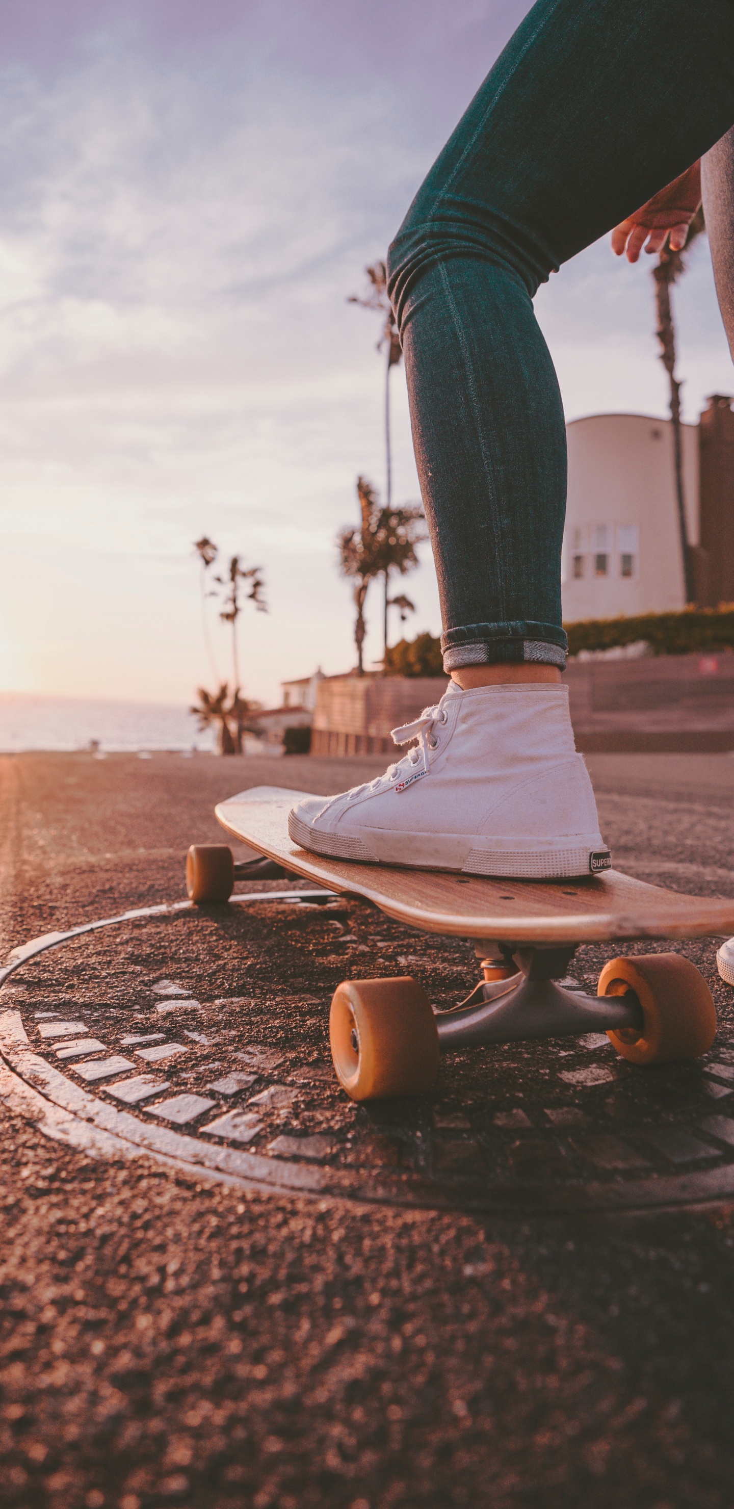 Person in Blue Denim Jeans and White Nike Sneakers Standing on Brown Concrete Floor During Daytime. Wallpaper in 1440x2960 Resolution