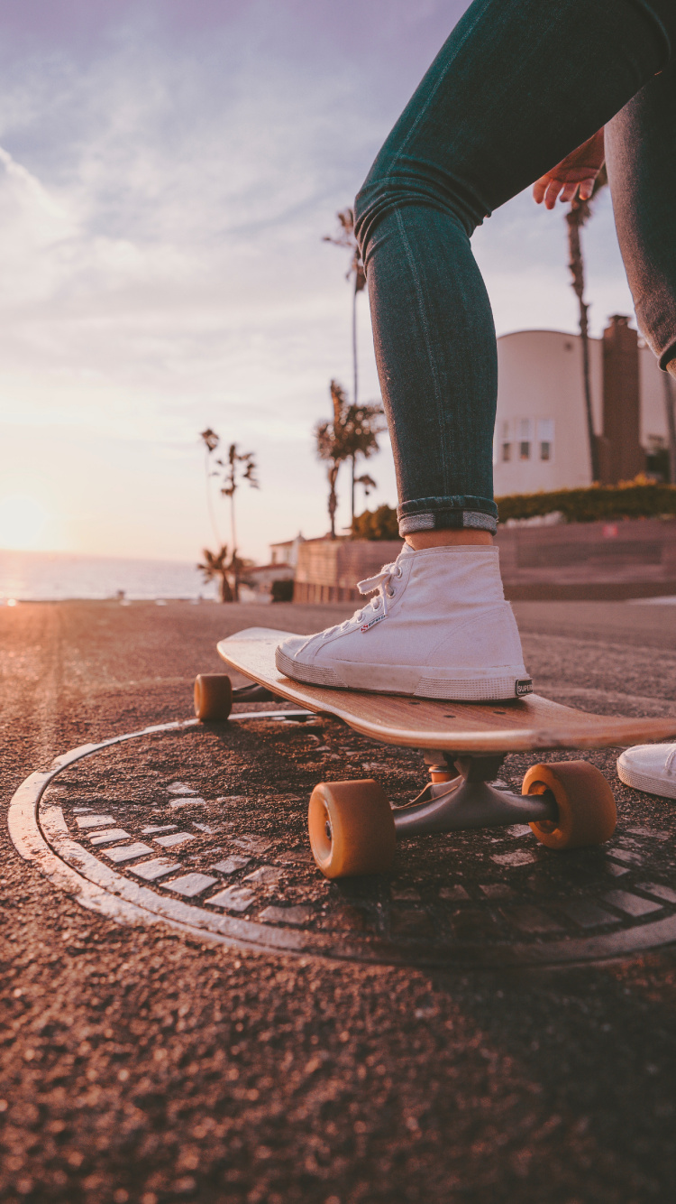 Person in Blue Denim Jeans and White Nike Sneakers Standing on Brown Concrete Floor During Daytime. Wallpaper in 750x1334 Resolution