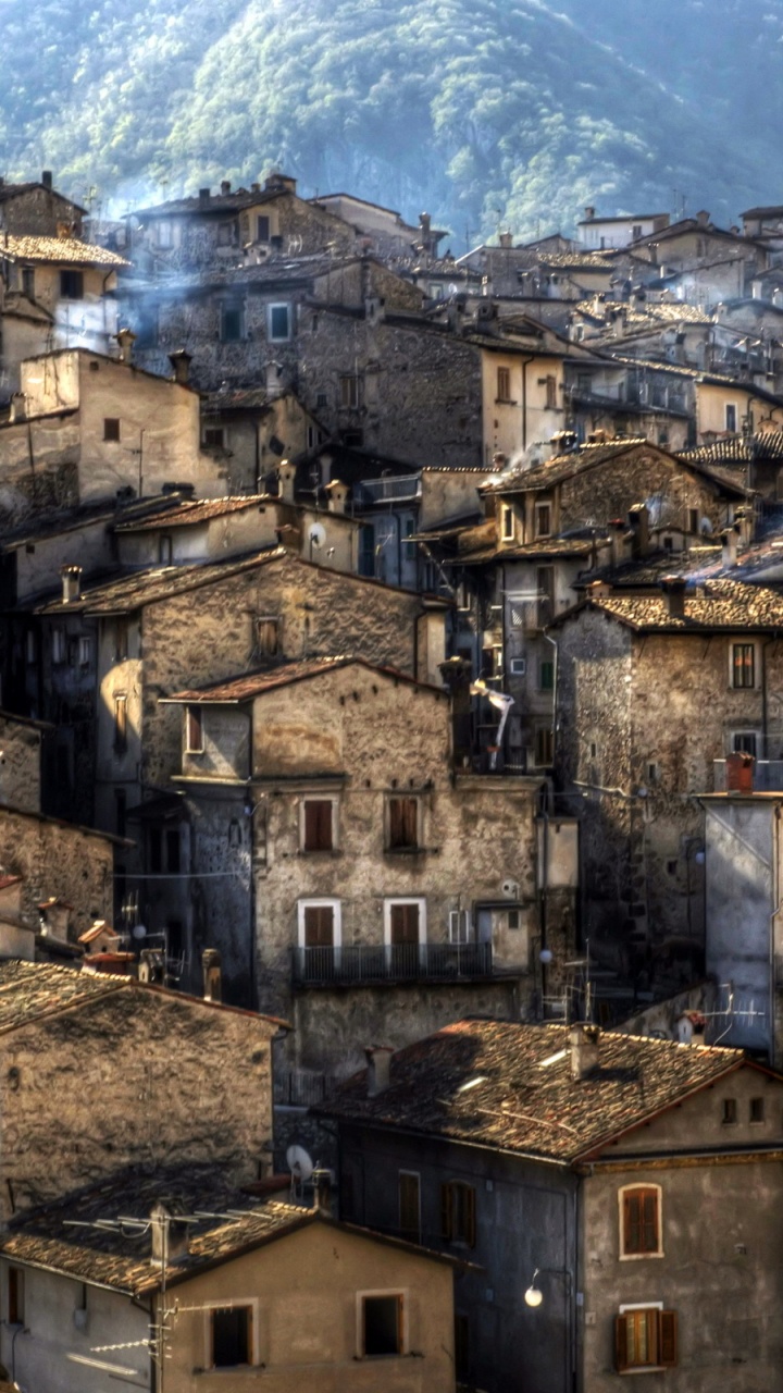 Brown Concrete Building Near Mountain During Daytime. Wallpaper in 720x1280 Resolution