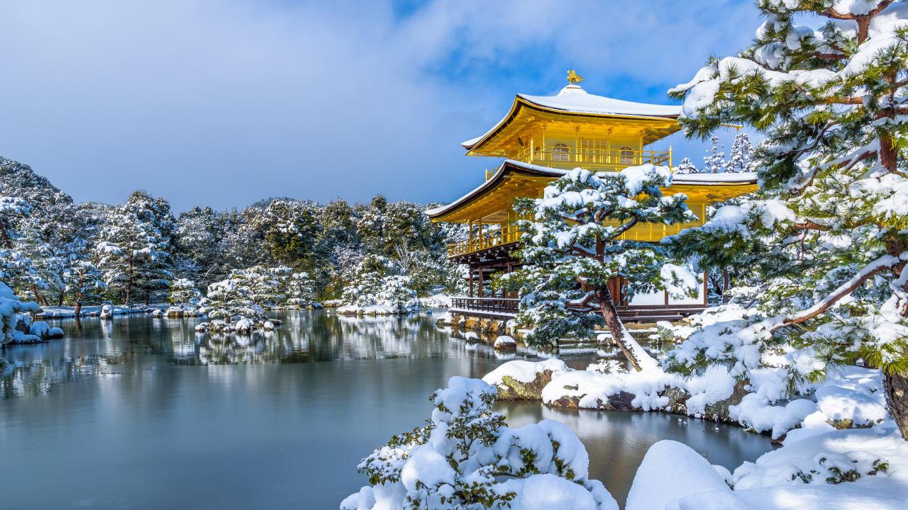 Brown and White Temple Near Body of Water Under Blue Sky During Daytime. Wallpaper in 1280x720 Resolution