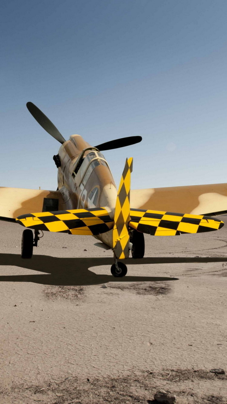 Yellow and White Plane on Gray Sand During Daytime. Wallpaper in 750x1334 Resolution