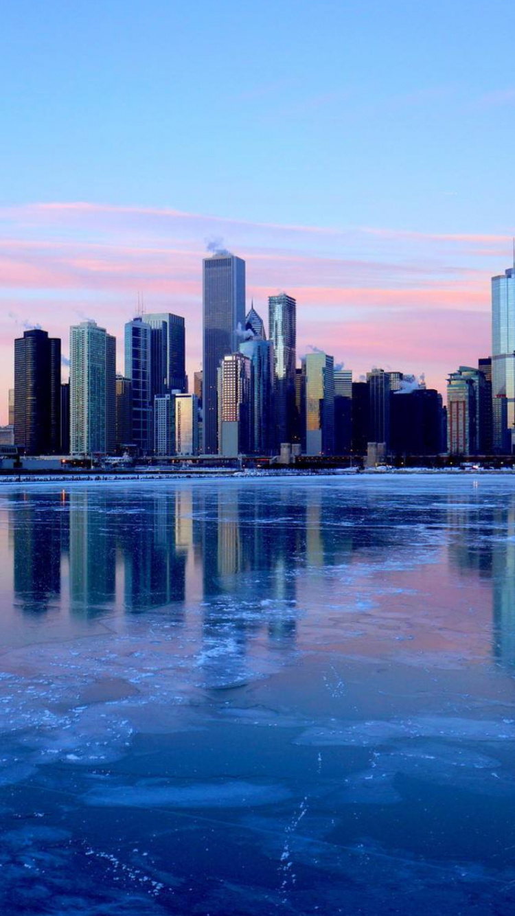 City Skyline Across Body of Water During Daytime. Wallpaper in 750x1334 Resolution