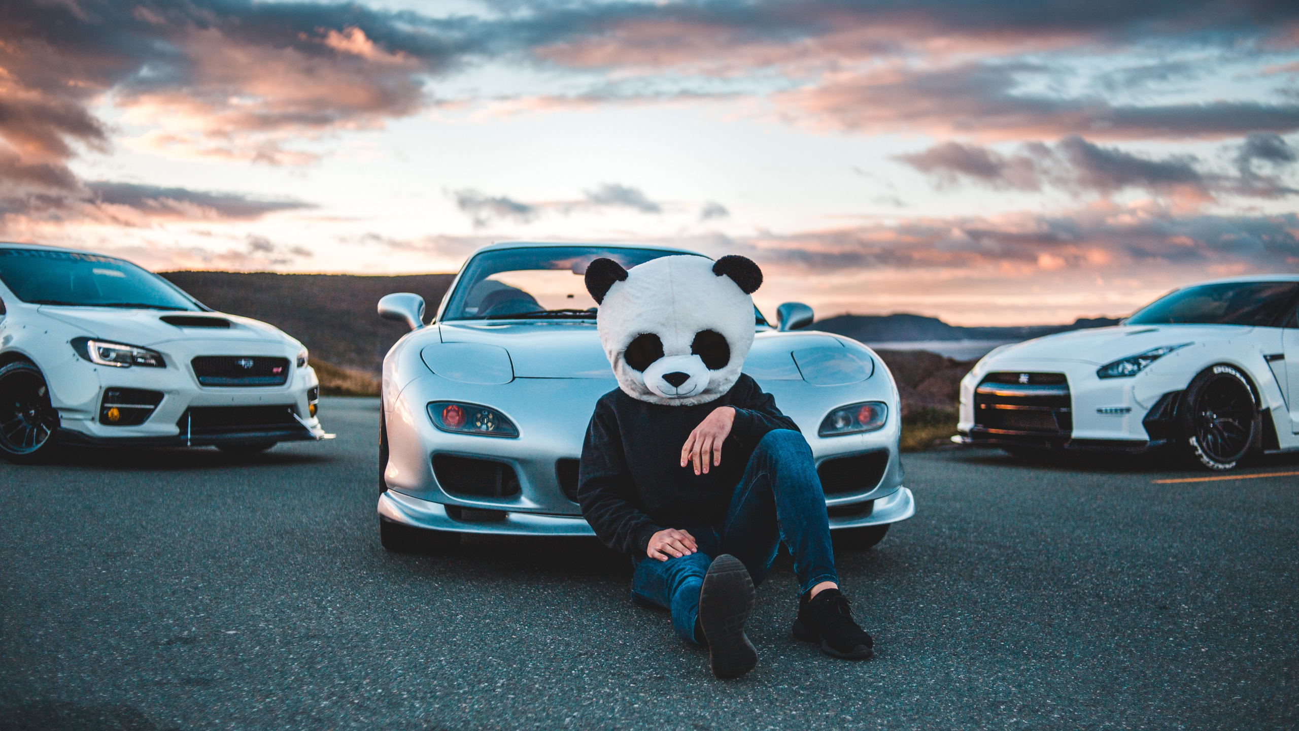 Mickey Mouse Plush Toy Sitting on Car Hood During Sunset. Wallpaper in 2560x1440 Resolution