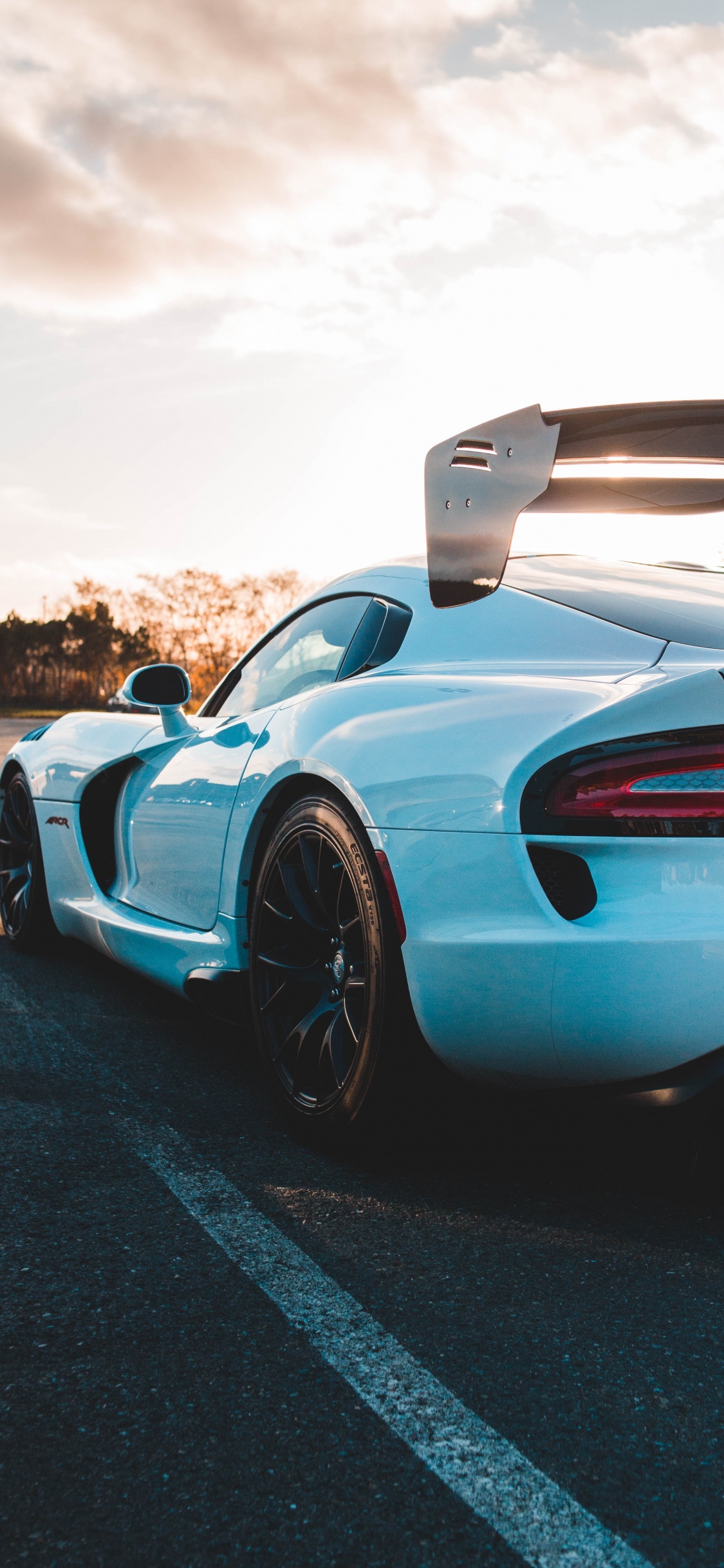 Blue and Black Sports Car on Road During Daytime. Wallpaper in 1125x2436 Resolution