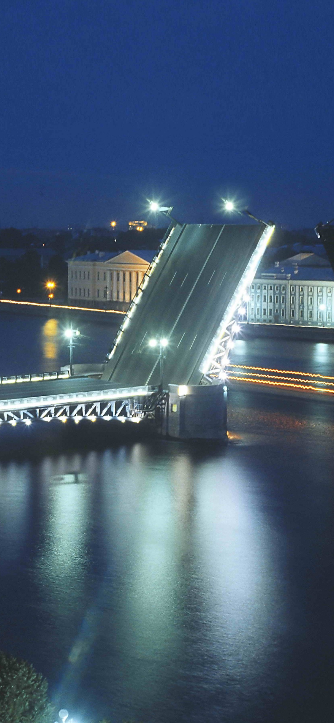 Bridge Over River During Night Time. Wallpaper in 1125x2436 Resolution