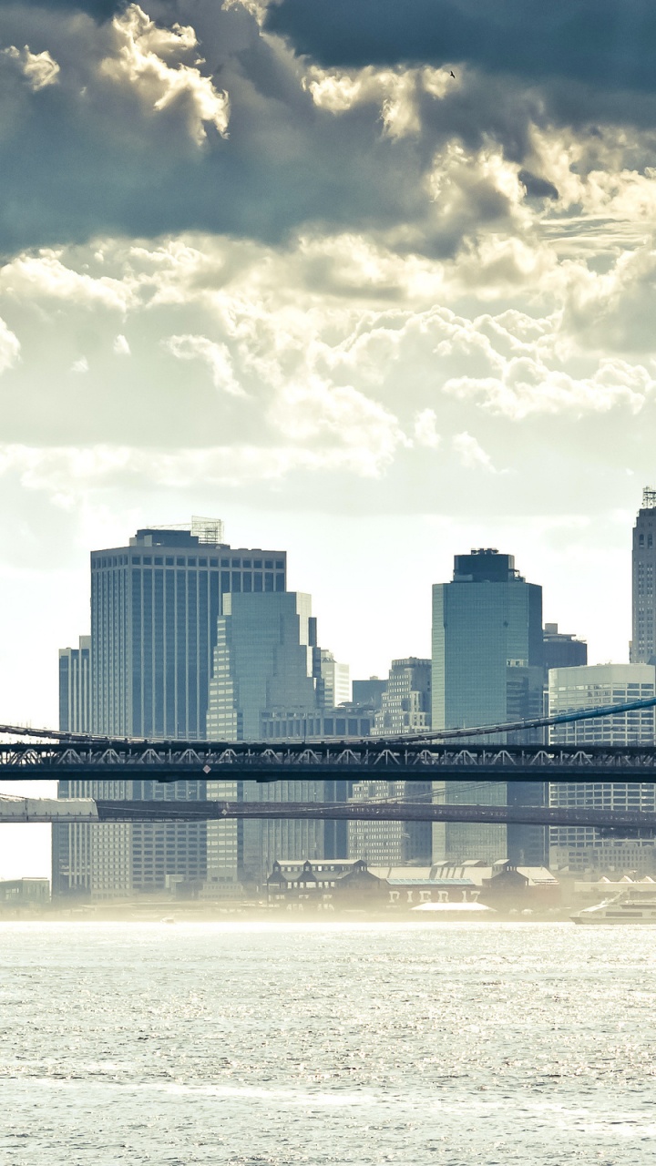 Bridge Over Water Near City Buildings During Daytime. Wallpaper in 720x1280 Resolution