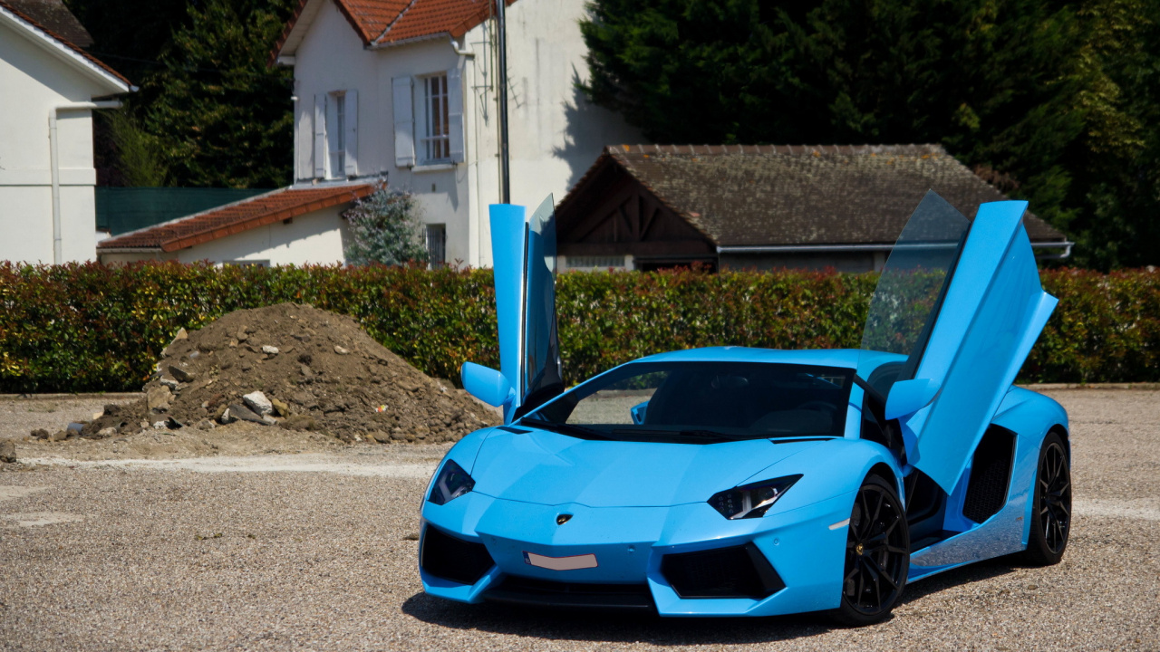 Blue Lamborghini Aventador Parked Near White Concrete Building During Daytime. Wallpaper in 1280x720 Resolution