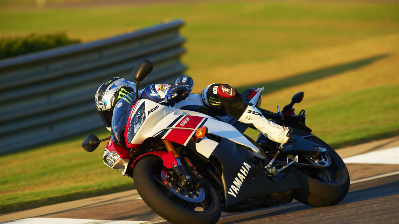 Man Riding on Red and White Sports Bike. Wallpaper in 1280x720 Resolution