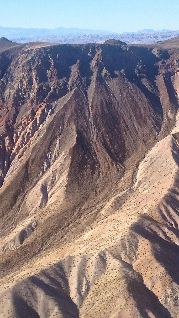 Brown Rocky Mountain Under Blue Sky During Daytime. Wallpaper in 750x1334 Resolution