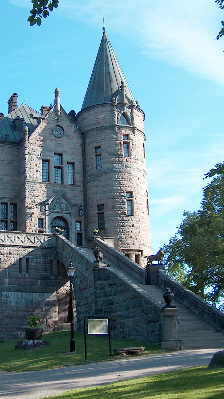 Grey Concrete Castle Under Blue Sky During Daytime. Wallpaper in 750x1334 Resolution