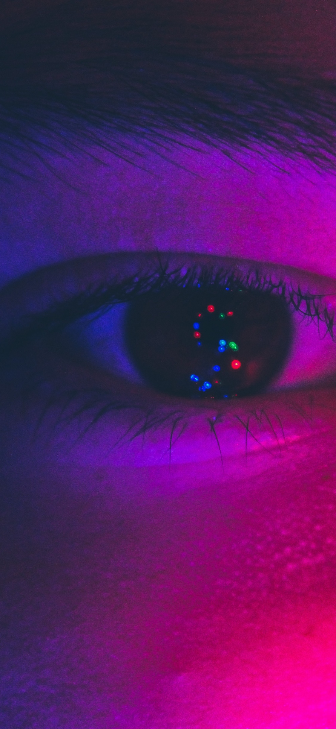 Persons Eye With Purple and Pink Eye. Wallpaper in 1125x2436 Resolution