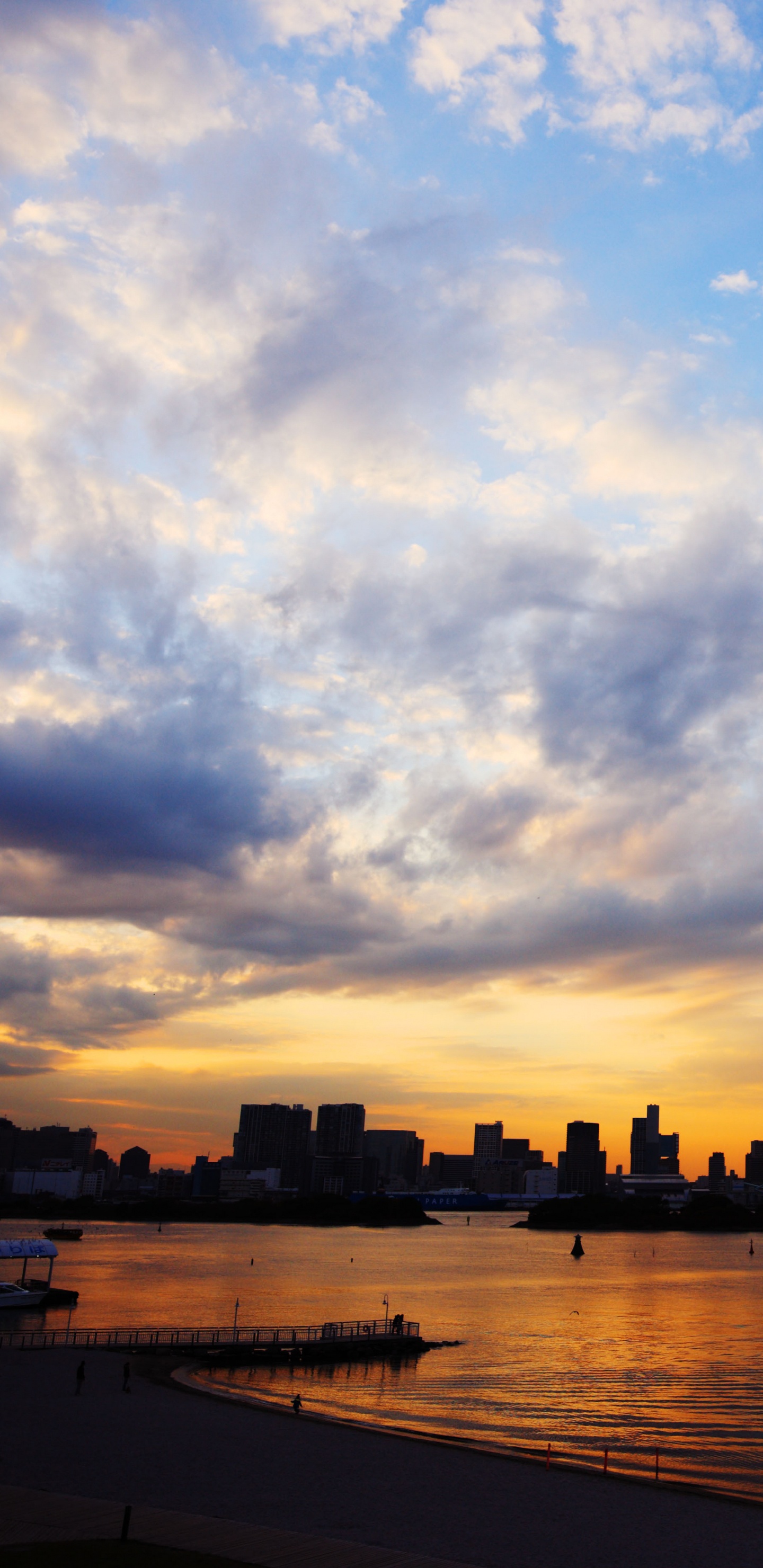 Silhouette of City Buildings Near Body of Water During Sunset. Wallpaper in 1440x2960 Resolution