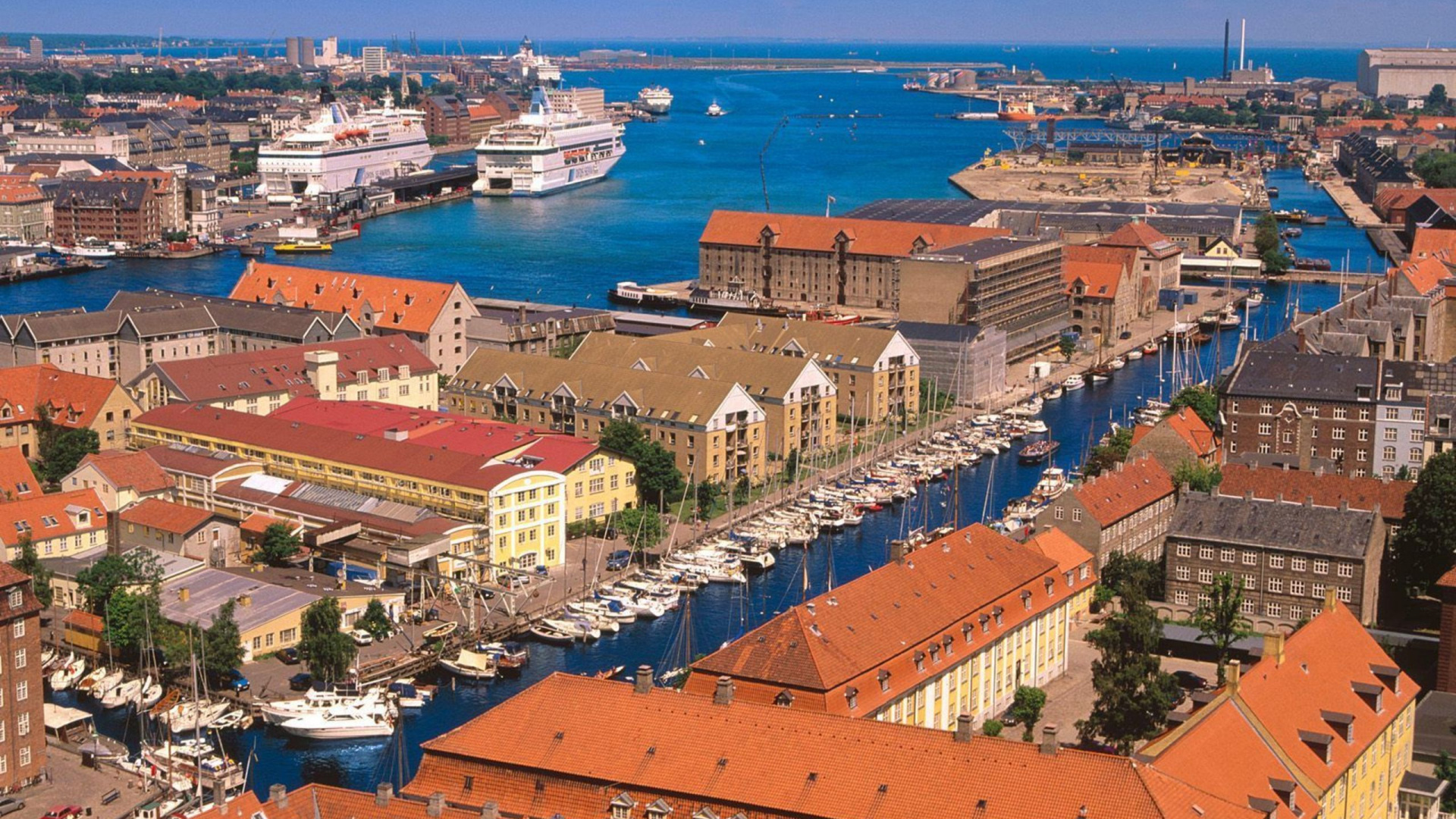 Aerial View of City Buildings Near Body of Water During Daytime. Wallpaper in 1920x1080 Resolution