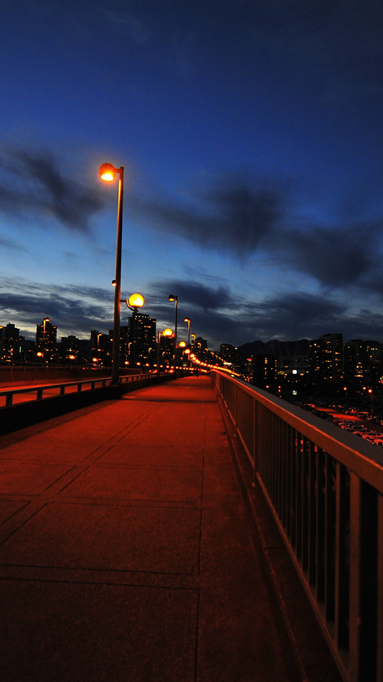 Brown Wooden Bridge During Night Time. Wallpaper in 750x1334 Resolution