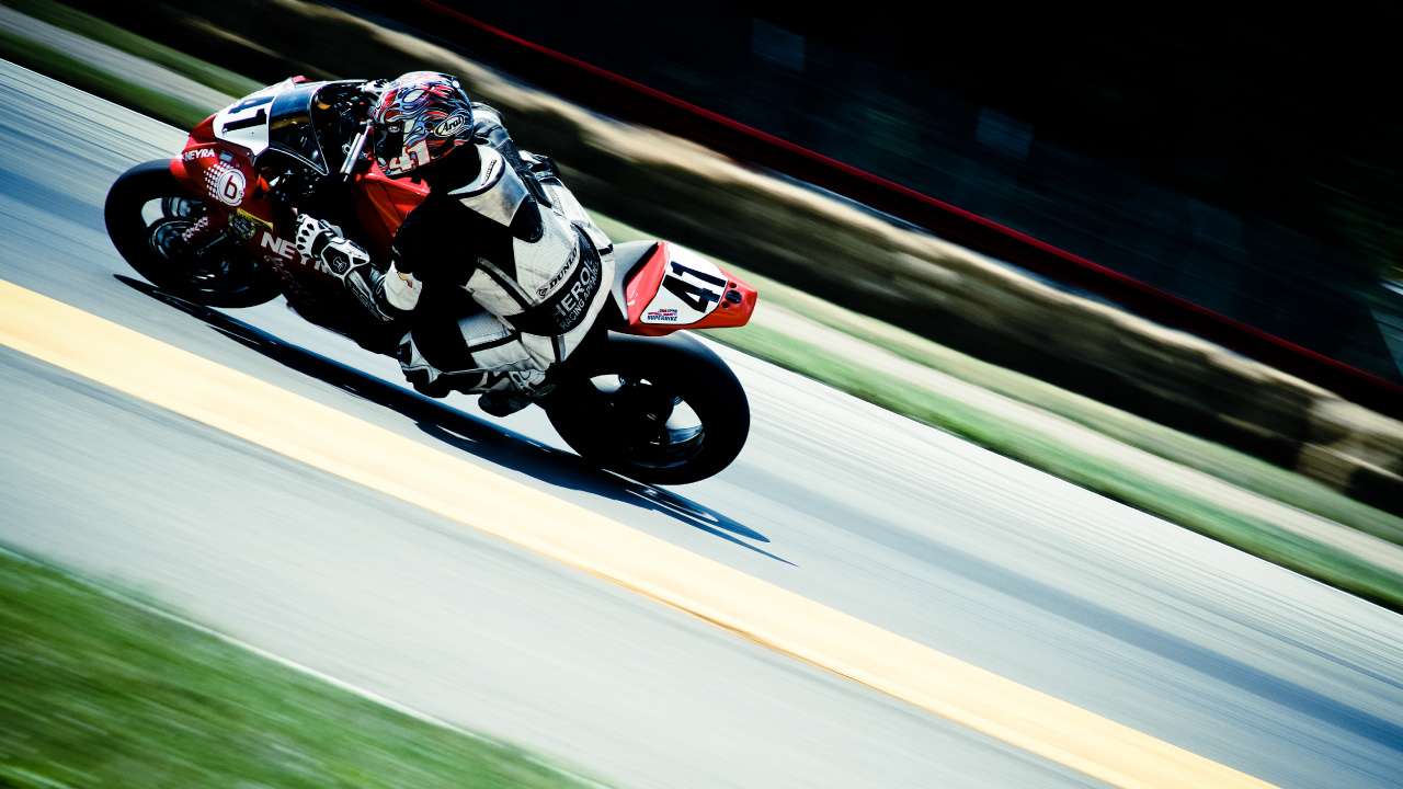Man in Red and White Racing Suit Riding on Sports Bike. Wallpaper in 1280x720 Resolution
