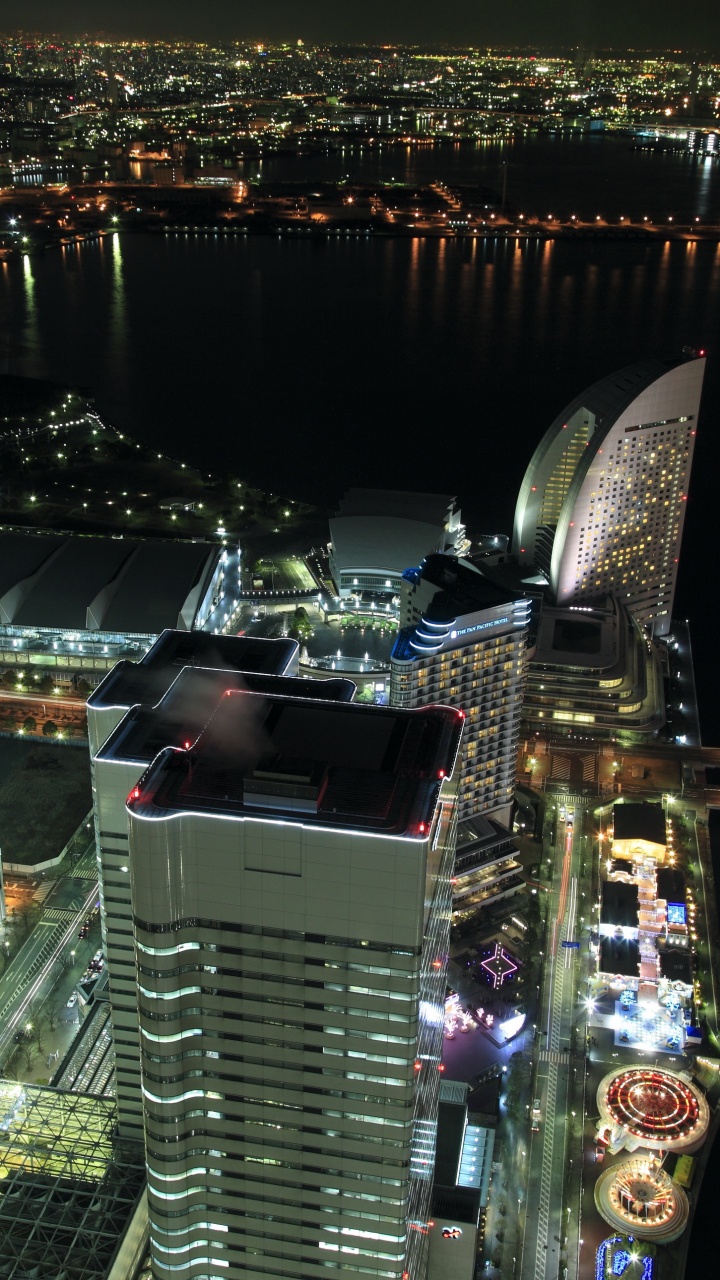 Vista Aérea de Los Edificios de la Ciudad Durante la Noche.. Wallpaper in 720x1280 Resolution