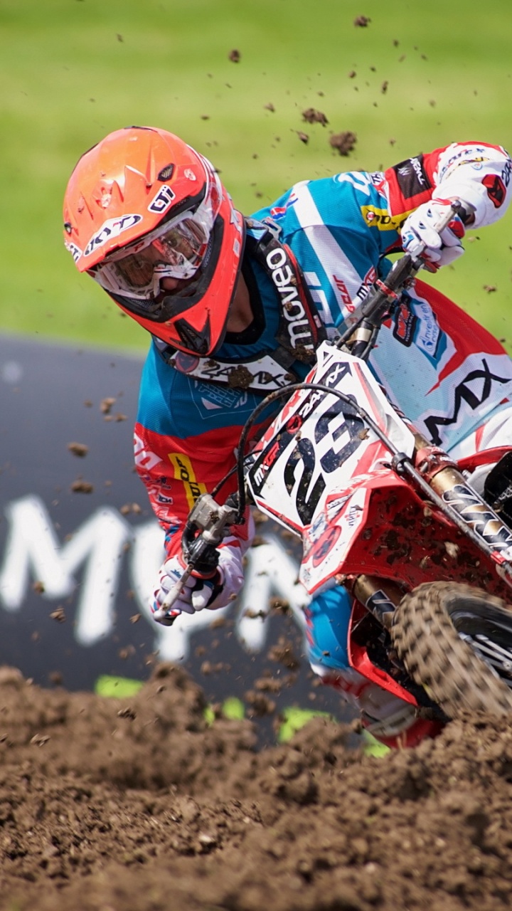 Man in Red and White Motocross Helmet Riding Motocross Dirt Bike. Wallpaper in 720x1280 Resolution