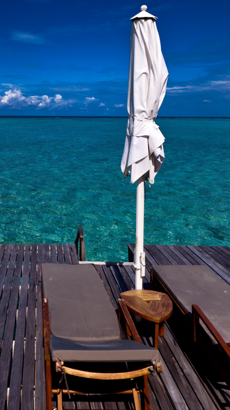 Brown Wooden Dock on Blue Sea Under Blue Sky During Daytime. Wallpaper in 750x1334 Resolution